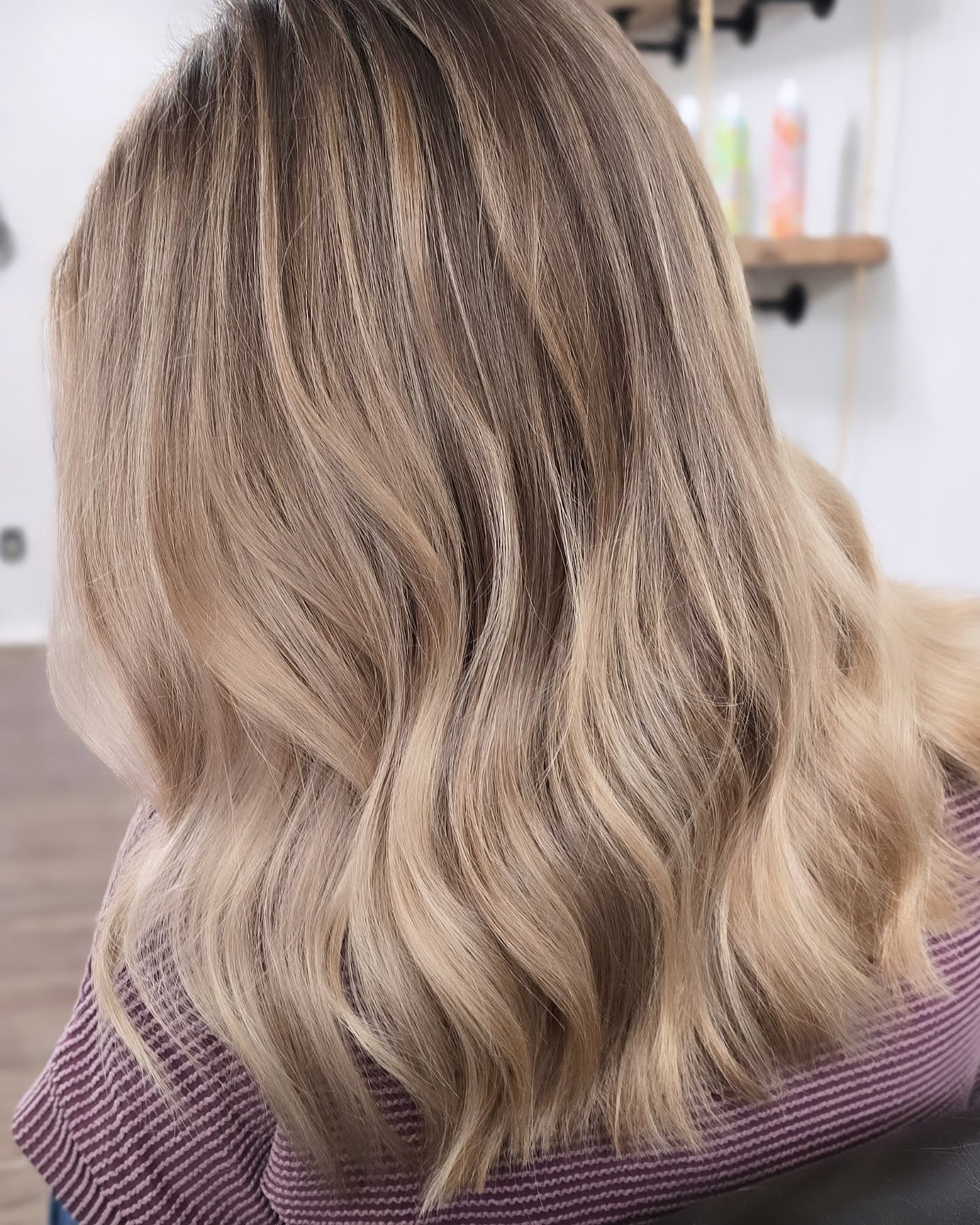 Warm blonde lived-in color with soft waves